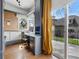 Bright home office featuring custom cabinets, built in desk, large window with view, and access to deck at 553 S Sherman St, Denver, CO 80209