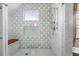Modern shower features patterned tile, a built-in shelf, and glass enclosure, creating a luxurious and functional space at 553 S Sherman St, Denver, CO 80209
