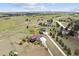 An aerial view showcases a sprawling residential property with mature trees and a long driveway at 2146 Savage Rd, Elizabeth, CO 80107