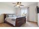 Cozy bedroom with warm tones, fan and a plush bed and neutral walls at 2146 Savage Rd, Elizabeth, CO 80107