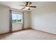 Bright bedroom featuring a neutral color scheme, a ceiling fan and a view at 2146 Savage Rd, Elizabeth, CO 80107
