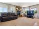 Comfortable living room featuring a stone fireplace and large windows for natural light at 2146 Savage Rd, Elizabeth, CO 80107