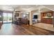 Open-concept living room with wood floors, connected to dining and kitchen areas at 2146 Savage Rd, Elizabeth, CO 80107