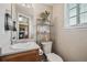 Updated powder room features a classic sink, decorative shelving, and a neutral color palette at 8199 Welby Rd # 1903, Denver, CO 80229