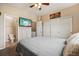Cozy bedroom features neutral walls, a ceiling fan, and ensuite bathroom for added privacy and convenience at 8199 Welby Rd # 1903, Denver, CO 80229