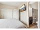 Bedroom featuring TV, closet, and doorway to an ensuite bathroom at 8199 Welby Rd # 1903, Denver, CO 80229