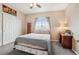 Bedroom with soft blue gray bedding, gray carpet and closet at 8199 Welby Rd # 1903, Denver, CO 80229