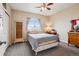 Bedroom with soft blue gray bedding and light filled window at 8199 Welby Rd # 1903, Denver, CO 80229
