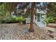 Exterior of a light green community building with white trim nestled among trees and a rock garden at 8199 Welby Rd # 1903, Denver, CO 80229