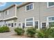 Exterior view of multiple townhomes with individual front door entry ways and minimal front yard landscaping at 8199 Welby Rd # 1903, Denver, CO 80229