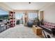 Sunlit living room offers access to the balcony, a textured rug and comfortable seating at 8199 Welby Rd # 1903, Denver, CO 80229