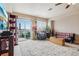 Bright living room featuring a sliding door to a patio, natural light, and neutral walls at 8199 Welby Rd # 1903, Denver, CO 80229