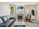 Cozy living room with a fireplace, comfortable seating, and natural light from large windows at 8199 Welby Rd # 1903, Denver, CO 80229