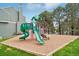 Exterior view of the community playground with slides and equipment, set on a wood chip base at 8199 Welby Rd # 1903, Denver, CO 80229