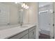 Bathroom featuring a long vanity with double lights, sink, and door to separate shower/toilet room at 24563 E 34Th Ave, Aurora, CO 80019
