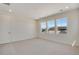 This bedroom features neutral carpet, recessed lights, and a view of the outdoors at 24563 E 34Th Ave, Aurora, CO 80019
