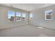 Empty bedroom features a neutral carpet, light walls and many large windows at 24563 E 34Th Ave, Aurora, CO 80019