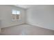 Bedroom featuring neutral carpet, one large window, and light colored walls at 24563 E 34Th Ave, Aurora, CO 80019