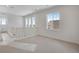 An upstairs bonus room with many windows and light carpet, ready for your personal touch at 24563 E 34Th Ave, Aurora, CO 80019