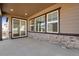 Covered patio area with sliding glass doors and stone accents at 24563 E 34Th Ave, Aurora, CO 80019