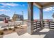 Covered front porch featuring brick pillars and view of the neighborhood at 24563 E 34Th Ave, Aurora, CO 80019
