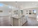 This open kitchen boasts a large island, stone countertops and views of the living space at 24563 E 34Th Ave, Aurora, CO 80019