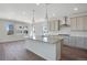 A modern kitchen has a granite island, pendant lights, and stainless steel appliances at 24563 E 34Th Ave, Aurora, CO 80019