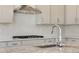 This kitchen features stainless steel appliances, light grey cabinets, and granite countertops at 24563 E 34Th Ave, Aurora, CO 80019