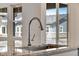 The kitchen features a stainless steel sink, granite countertop, and view to the outdoors at 24563 E 34Th Ave, Aurora, CO 80019