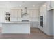 This open kitchen features stainless steel appliances, a large island, and shaker cabinets at 24563 E 34Th Ave, Aurora, CO 80019