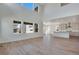 An open-concept living room with views of the eat-in kitchen with white cabinets at 24563 E 34Th Ave, Aurora, CO 80019