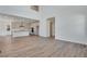 An open-concept living room view of the eat-in kitchen with white cabinets at 24563 E 34Th Ave, Aurora, CO 80019