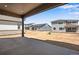 A covered patio featuring a concrete floor and an exterior view of neighboring homes at 24563 E 34Th Ave, Aurora, CO 80019