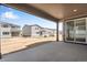 A covered patio featuring a concrete floor with an exterior view of neighboring homes at 24563 E 34Th Ave, Aurora, CO 80019