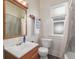 Updated bathroom featuring a wood vanity, a shower with a tile surround, and a toilet at 219 Terry St, Longmont, CO 80501