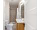 Full bathroom featuring a tiled shower with a glass door and a white vanity at 219 Terry St, Longmont, CO 80501