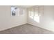 Simple bedroom with grey carpet, built-in shelves, and a window at 219 Terry St, Longmont, CO 80501
