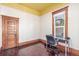 This bedroom features original wood trim, hardwood floors, and large windows at 219 Terry St, Longmont, CO 80501