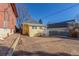 Back exterior of yellow house with gravel area at 219 Terry St, Longmont, CO 80501