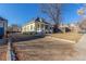 Front view of charming yellow house with yard at 219 Terry St, Longmont, CO 80501