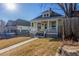 Charming yellow single-Gathering home featuring a welcoming front porch and well-maintained lawn at 219 Terry St, Longmont, CO 80501