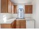 Well lit kitchen with wooden cabinets, white countertops, and a modern dishwasher at 219 Terry St, Longmont, CO 80501