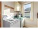 Functional kitchen features white appliances, ample counter space, and bright natural light from a window at 219 Terry St, Longmont, CO 80501