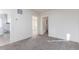A carpeted living room leads to an open layout and a bathroom with neutral colors at 219 Terry St, Longmont, CO 80501