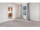 Cozy carpeted living room open to the kitchen with natural light at 219 Terry St, Longmont, CO 80501