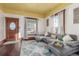 Living room with sectional sofa, hardwood floors, and view to kitchen at 219 Terry St, Longmont, CO 80501