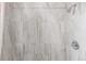 Close-up of a shower with elegant and neutral tile, complemented by brushed chrome hardware at 219 Terry St, Longmont, CO 80501