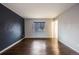 Bedroom with hardwood floors, a window, and neutral walls at 8340 E Princeton Ave, Denver, CO 80237