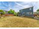 Spacious backyard featuring a deck, wooden fence, grill under pergola, and lush green grass at 1086 Mockingbird St, Brighton, CO 80601