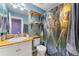 Stylish bathroom features a rustic countertop with decor, novelty shower curtain and teal paint at 1086 Mockingbird St, Brighton, CO 80601